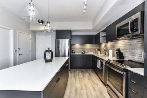 Fully equipped kitchen with a breakfast counter (seats 3) and a dining area (seats 4), plus a high chair available for little ones.