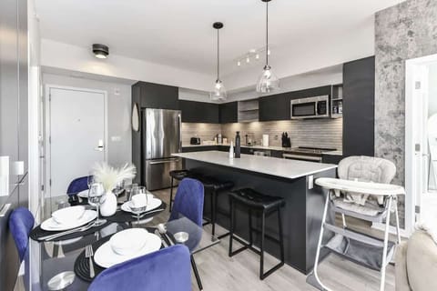 Fully equipped kitchen with a breakfast counter (seats 3) and a dining area (seats 4), plus a high chair available for little ones.