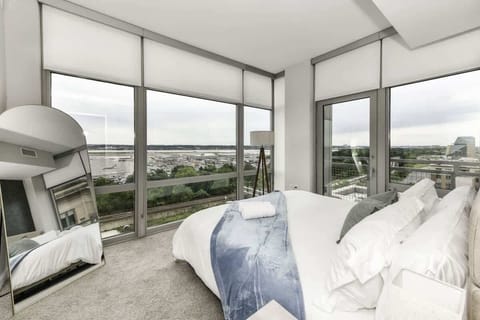 Runway Views ✈️ Relax in a modern king bedroom with floor-to-ceiling windows to watch planes land & take off right from your bed!