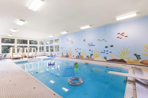Bask in the warm waters of the indoor heated pool, equipped with a diving board and pool toys.