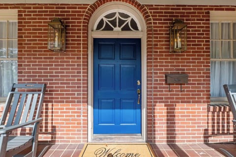 "Charming brick-walled entryway offers a warm welcome and timeless character as you step inside."