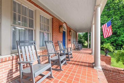 "Charming brick porch with comfortable seating — the perfect spot to relax."