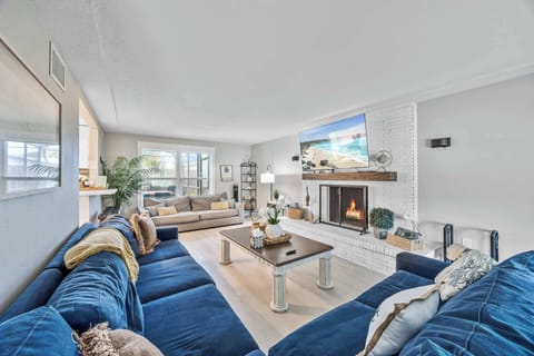 Spacious living room with a cozy fireplace and large windows for natural light