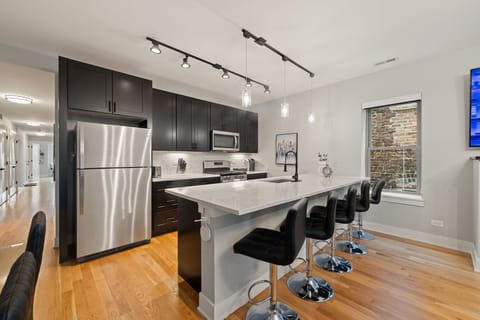 Sleek kitchen w/ stainless appliances & a roomy island for cooking together.