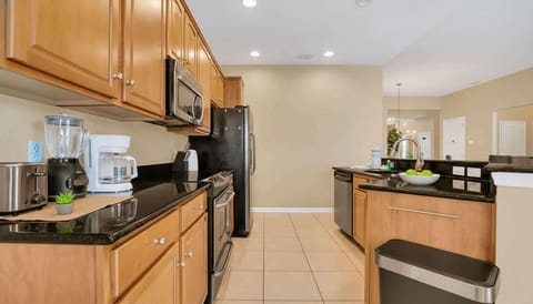 Experience culinary bliss in this light-filled kitchen, where classic oak meets sleek granite.