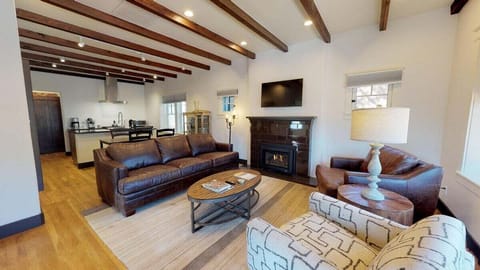 Beautiful tile fireplace and wood beams in living area