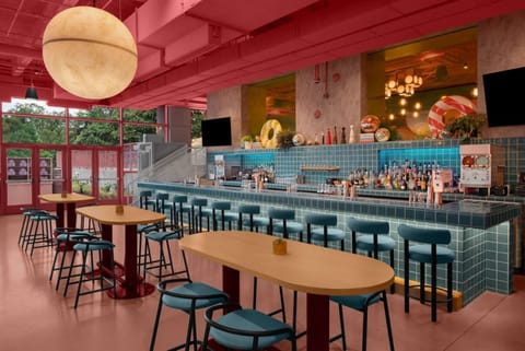 Bright bar area with teal counter and pink walls
