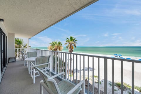 Oceanfront balcony w/ seating, perfect for morning coffee & endless blue-water views.
