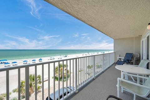Relax on the breezy balcony w/ comfy seating and sweeping ocean views just beyond the railing.