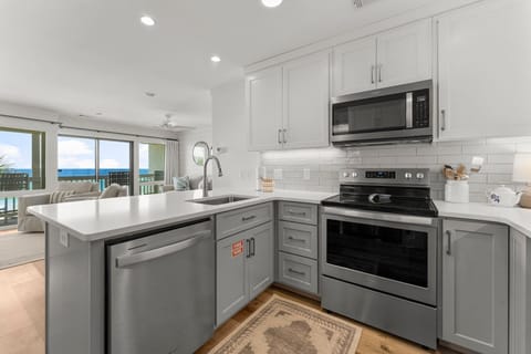 The fully equipped kitchen features quartz countertops, stainless-steel appliances, and has everything you need to prepare meals.