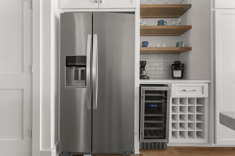 The fully equipped kitchen features quartz countertops, stainless-steel appliances, and has everything you need to prepare meals.