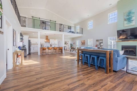 Open-concept living flows into kitchen and dining, with a stylish loft to relax