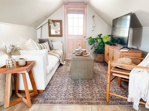 Cozy Living room perfect to cozy up and watch your favorite show after a day at the beach! even more cozy is the reading nook to the right of the living room with a second tv and a small daybed.  