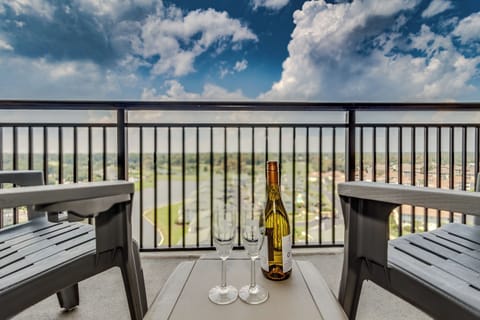 Sip wine on your private balcony while taking in sweeping city views and dramatic cloud formations above.