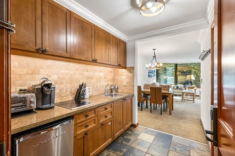 Your fully equipped kitchen features rich wood cabinetry, granite counters, and quality appliances for preparing meals during your stay.