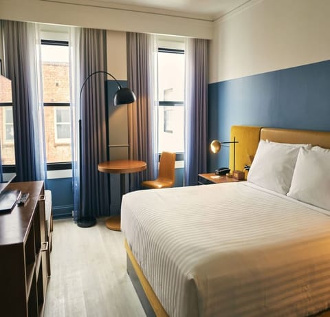 Start your day with sunlight streaming across a serene bed.