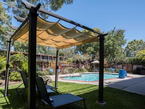 Relax under the canopy with pool views and cool breezes.