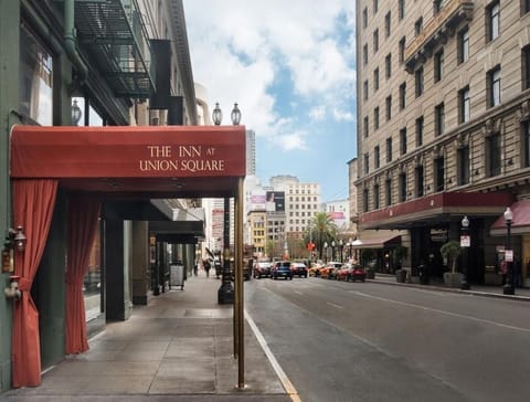 Arrive in style beneath the iconic canopy on a lively street.