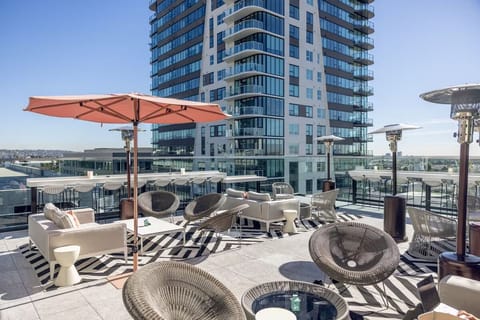 Gather with friends on a spacious rooftop lounge in the sun.
