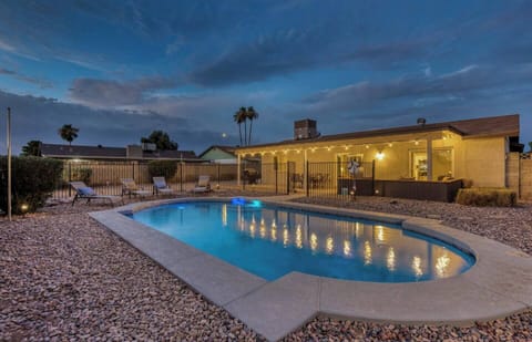 Large private backyard with heated swimming pool