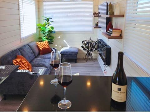 Living Room Retreat: Sip wine by the modern fireplace in this stylish and bright gathering space!