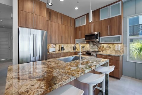Sleek kitchen with bar seating and open floor plan