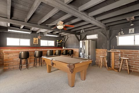 Poolside cantina: long bar, 6 stools, fridge, pool table & 50” ROKU TV.