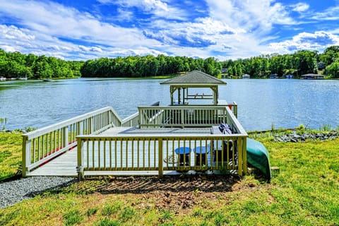 Dock - Covered dock with boat lift, sundeck, and gazebo on the quiet cove with canoe stored at the shore.