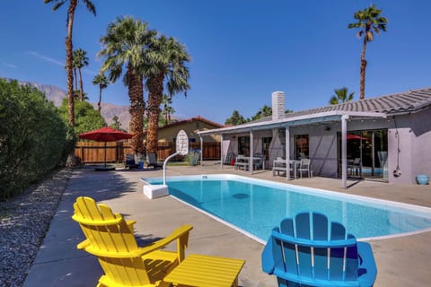 Private Palm Springs backyard with pool, lounge chairs, and mountain views
