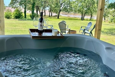 Unwind in your private hot tub with a glass of wine and the serene sounds of the lake