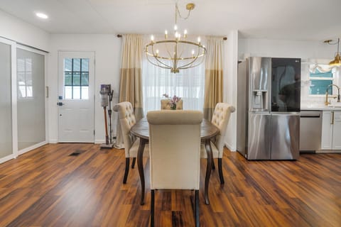 Stylish dining area with seating for six and modern chandelier
