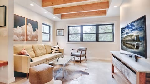 Bright + Inviting Living Room: Kick back and relax in this cozy, sun-filled space featuring a Smart TV, comfy seating, and warm, Scandinavian-inspired decor.
