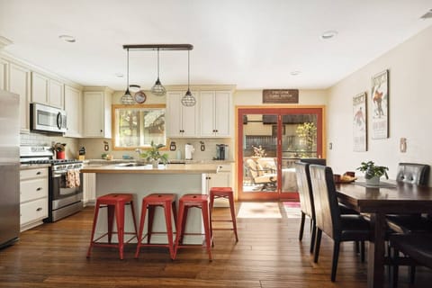 An open-concept kitchen and dining area with easy access to the deck, complete with outdoor dining furniture.