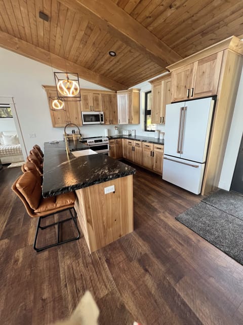 Large kitchen with brand new appliances and 5 bar stools. Dining area seats 11.