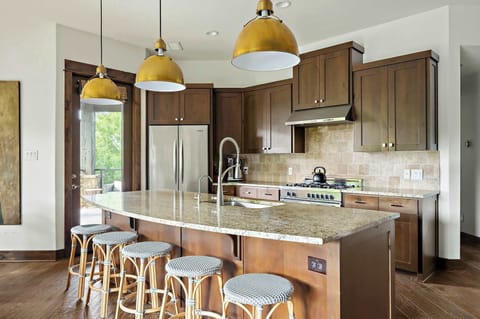 The fully equipped kitchen is ideal for everything from quick breakfasts to full dinners, complete with a breakfast bar and a dining table that seats eight for memorable meals and gatherings.