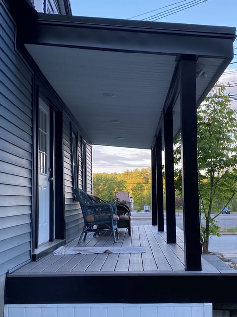 Front porch for the first unit, with nice refurbished chairs. 
