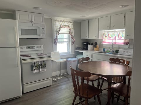 The fully equipped kitchen as well as a place to sit down and eat. 