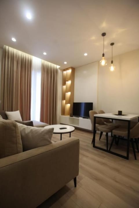 Apartment | Living area | 50-inch flat-screen TV with satellite channels