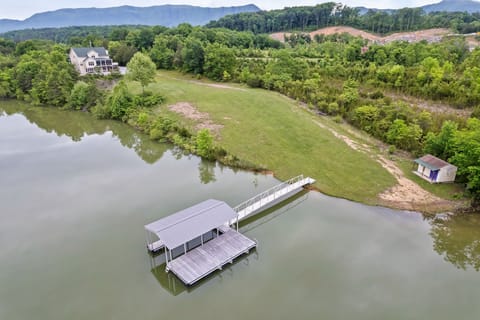 Covered boat slip with 80' bridge to deep water.