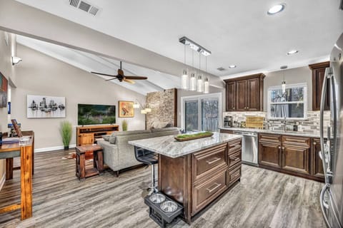 Recently remodeled, the kitchen features granite countertops, stainless steel appliances, modern cabinetry, and an open layout. Enjoy Austin-inspired decor while making your favorite meals in this fully-stocked kitchen.