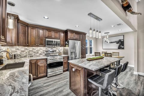 Recently remodeled, the kitchen features granite countertops, stainless steel appliances, modern cabinetry, and an open layout. Enjoy Austin-inspired decor while making your favorite meals in this fully-stocked kitchen.