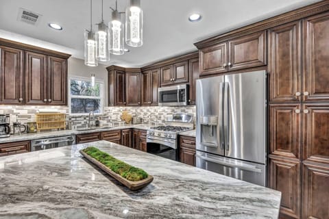Recently remodeled, the kitchen features granite countertops, stainless steel appliances, modern cabinetry, and an open layout. Enjoy Austin-inspired decor while making your favorite meals in this fully-stocked kitchen.