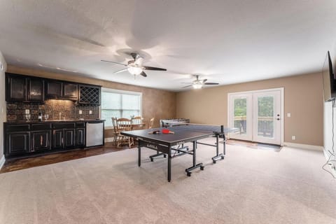 Ping pong, foosball and family game table, plus large TV and wet bar game room