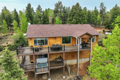 Welcome to this beautiful Woodland Park retreat, a spacious two-story cabin surrounded by peaceful pine trees. With a floor-to-ceiling stone fireplace, large windows framing forest views, and warm finishes throughout, this home offers the perfect set