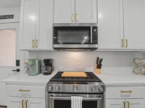 Fully equipped kitchen with stainless appliances and coffee station