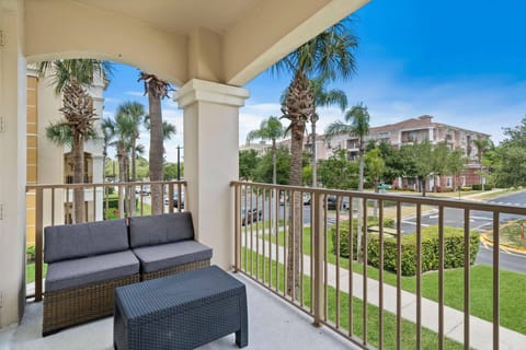 Step onto your private balcony, where sleek gray seating invites you to relax amidst the lush palm trees swaying in the breeze. Enjoy the expansive view that balances tranquility with vibrant surroundings, perfect for unwinding.
