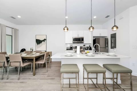 Gather around the spacious dining table, perfect for shared meals and laughs.