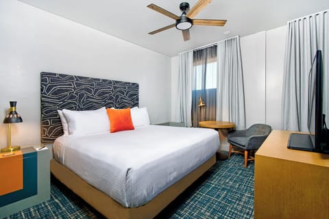 Relax after exploring in a sleek room with warm lighting.