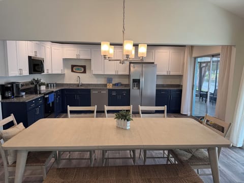 Open large kitchen with large dining table. 