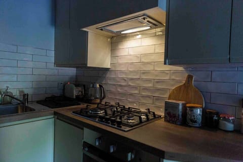 Compact kitchen with gas hob and fridge freezer, cupboards with full supply of kitchen ware. Coffee teas and herbs and spices for cooking supplied 